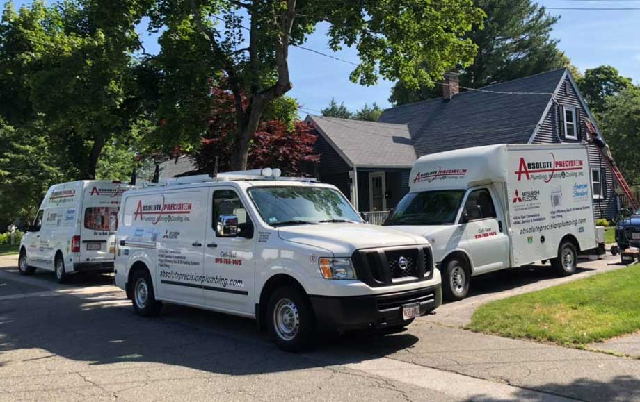 Absolute Precision Plumbing Heating & Cooling vans on jobsite in Beverly, MA